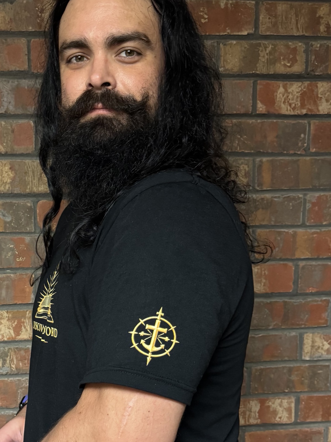 Left sleeve with the gold cross, anchor, and compass emblem