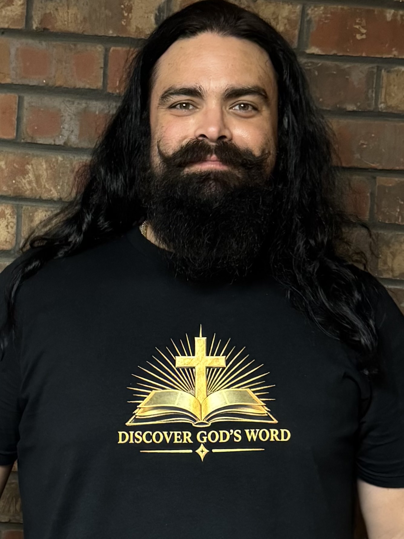 David wearing the black Discover God's Word shirt, showing the gold Bible and cross logo